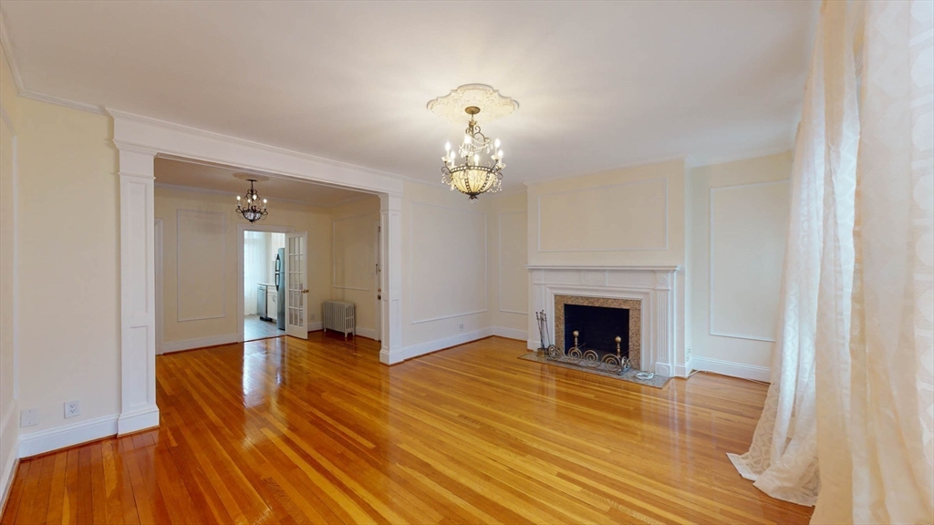 311 Tappan Street, Unit 3 Brookline, MA 02445 - Photo 7 of 35 a view of livingroom with fireplace chandelier and wooden floor