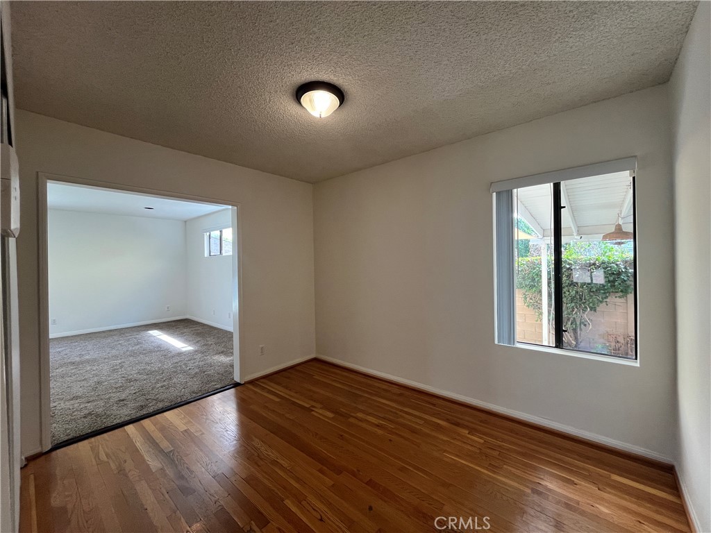 18029 Santa Rita Street Encino, CA 91316 - Photo 11 of 20 an empty room with wooden floor and windows