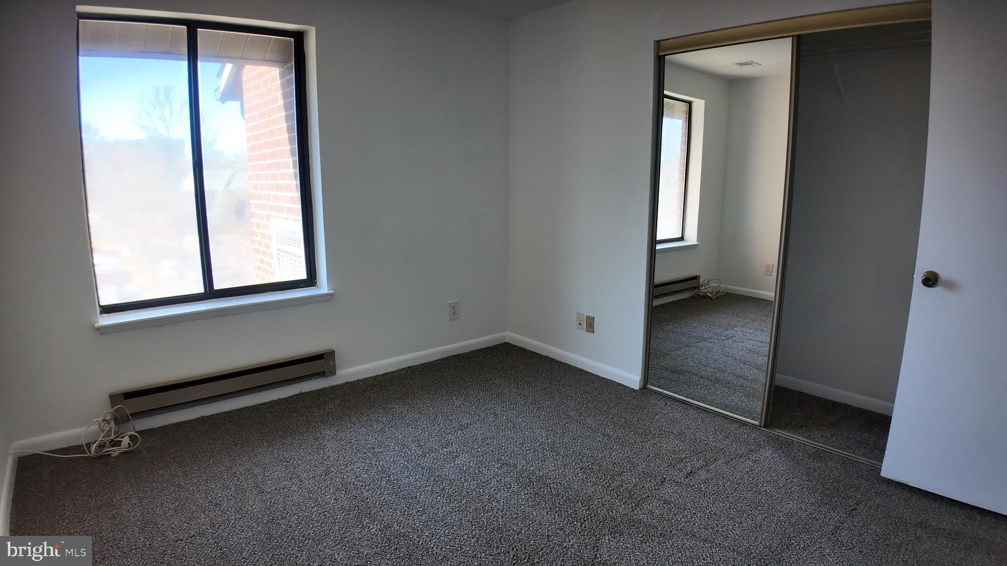 15311 Beaverbrook Court, Unit 903B Silver Spring, MD 20906 - Photo 21 of 36 an empty room with a window and a hallway