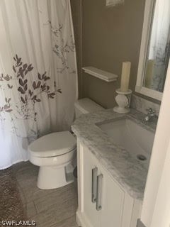 15031 Punta Rassa Road, Unit 206 Fort Myers, FL 33908 - Photo 16 of 23 a bathroom with a granite countertop toilet and a sink
