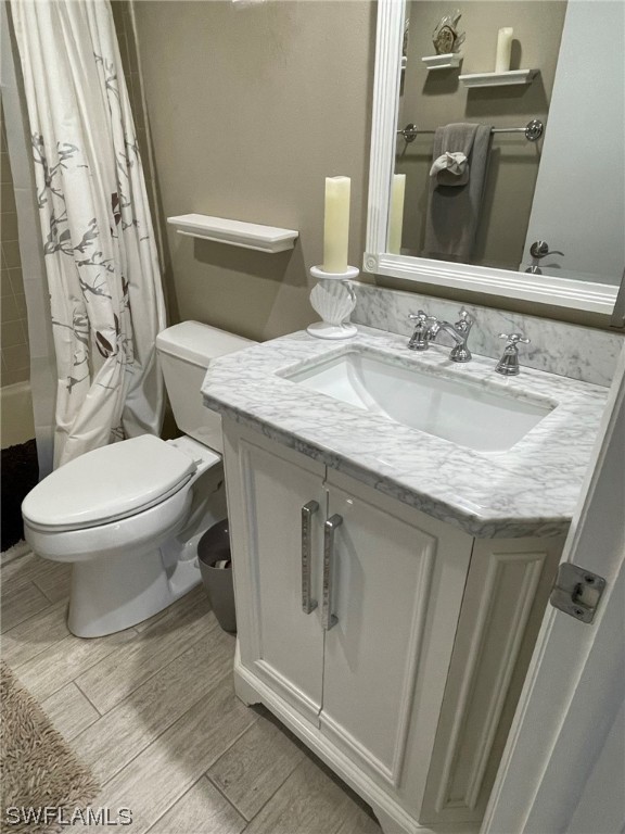 15031 Punta Rassa Road, Unit 206 Fort Myers, FL 33908 - Photo 17 of 23 a bathroom with a granite countertop toilet sink and mirror
