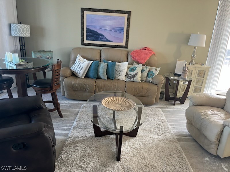 15031 Punta Rassa Road, Unit 206 Fort Myers, FL 33908 - Photo 2 of 23 a living room with furniture and a rug