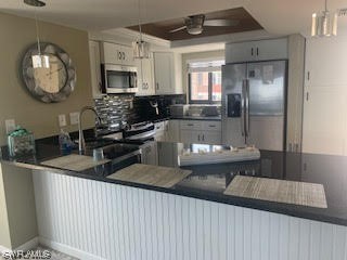 15031 Punta Rassa Road, Unit 206 Fort Myers, FL 33908 - Photo 3 of 23 a kitchen with sink a microwave and cabinets