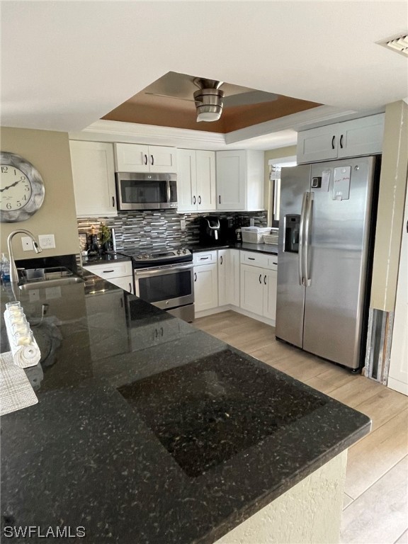 15031 Punta Rassa Road, Unit 206 Fort Myers, FL 33908 - Photo 6 of 23 a large white kitchen with stainless steel appliances