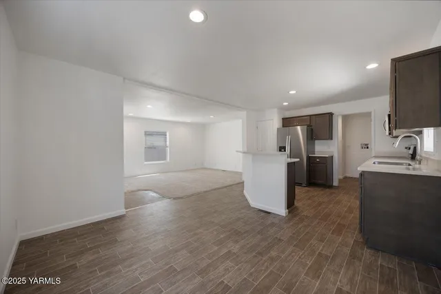 a view of a kitchen with a sink and a refrigerator