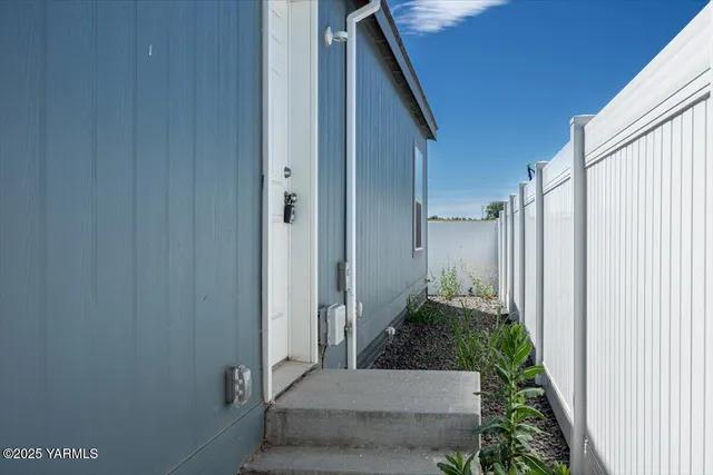 a view of small house with backyard