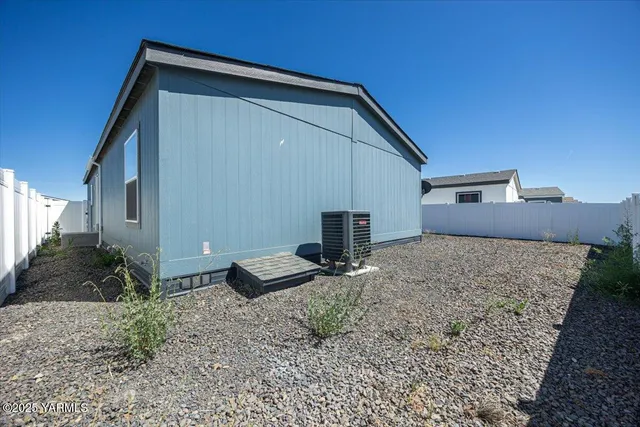 a front view of house with backyard and trees
