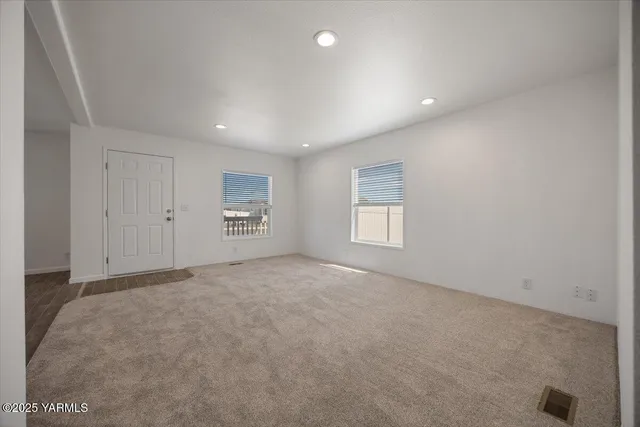 an empty room with a empty space and windows