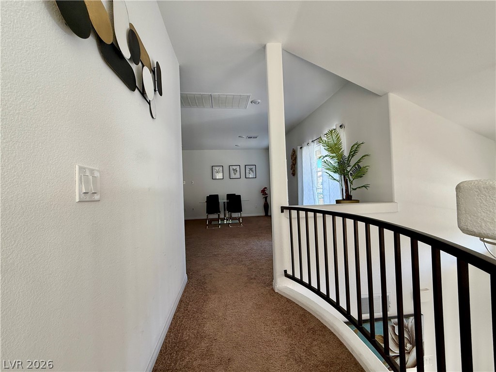 7777 South Westwind Road Las Vegas, NV 89139 - Photo 43 of 46 A graceful curved railing and vaulted ceiling distinguish this upper-level hallway.
