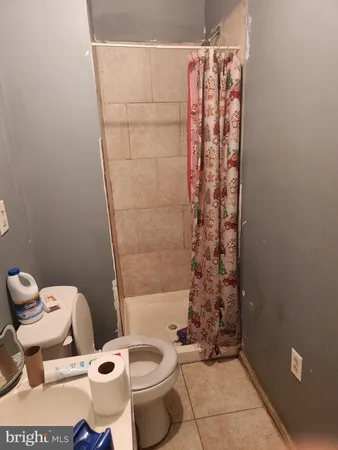 a bathroom with a toilet and shower