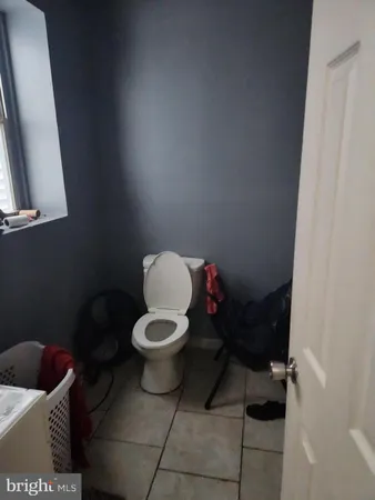 a bathroom with a toilet and a mirror