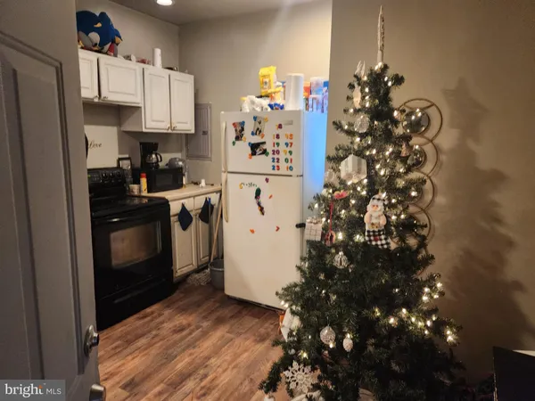 a kitchen with granite countertop a refrigerator and a stove
