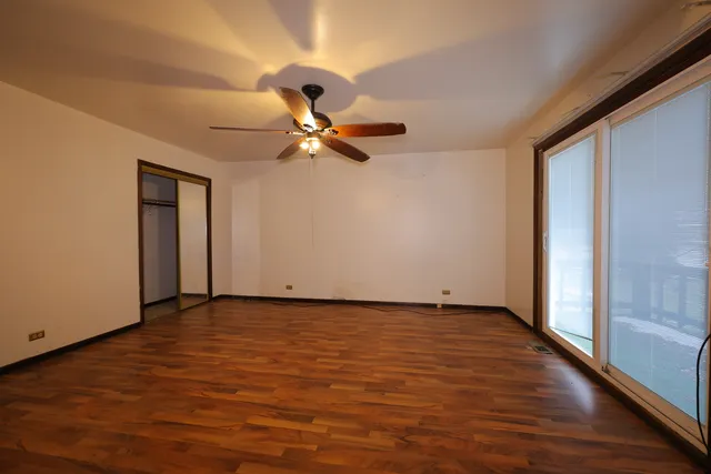 a view of room with a ceiling fan and hardwood floor