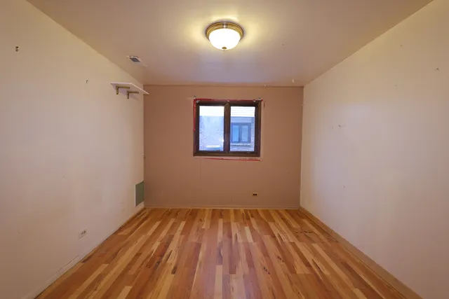 a view of a room with wooden floor and bathroom
