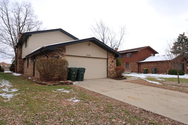a view of a house with a yard covered in snow
