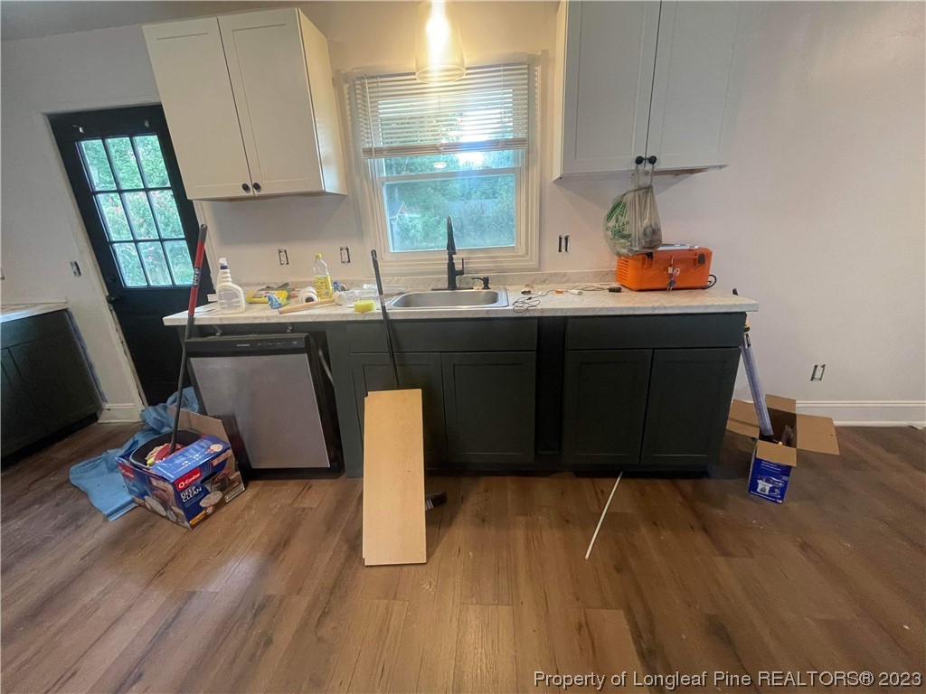 3013 Huntley Street Spring Lake, NC 28390 - Photo 2 of 8 a kitchen with stainless steel appliances granite countertop a sink dishwasher stove and cabinets with wooden floor
