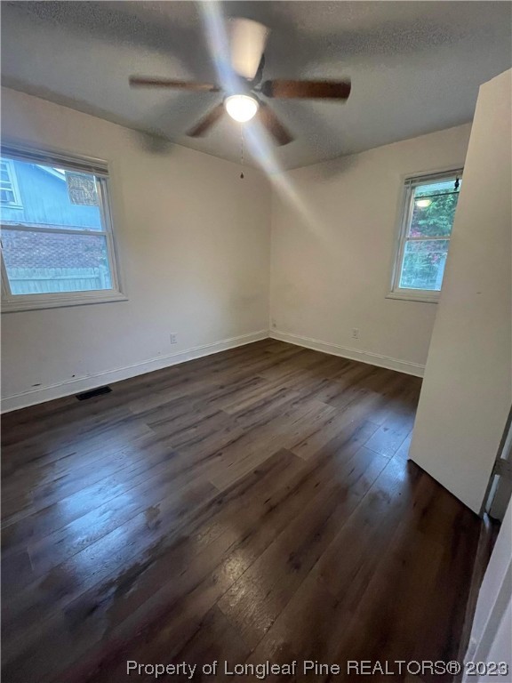 3013 Huntley Street Spring Lake, NC 28390 - Photo 7 of 8 an empty room with wooden floor chandelier fan and windows