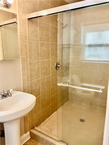 a bathroom with a shower and a sink