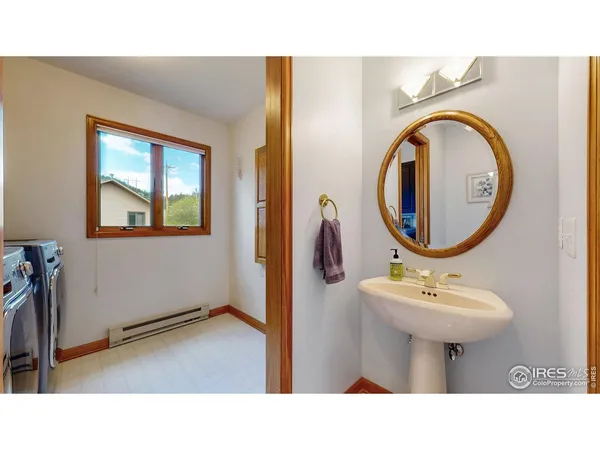 a bathroom with a sink mirror and toilet