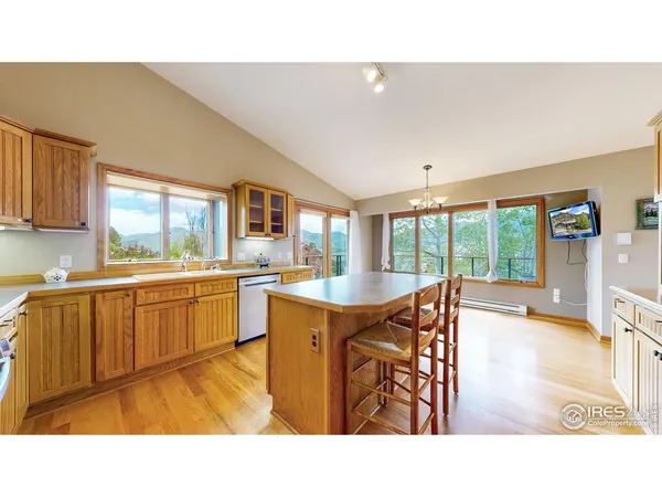 a kitchen with a sink cabinets and wooden floor