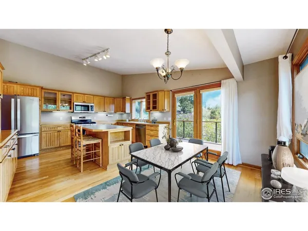 a living room with stainless steel appliances kitchen island granite countertop furniture and a dining table