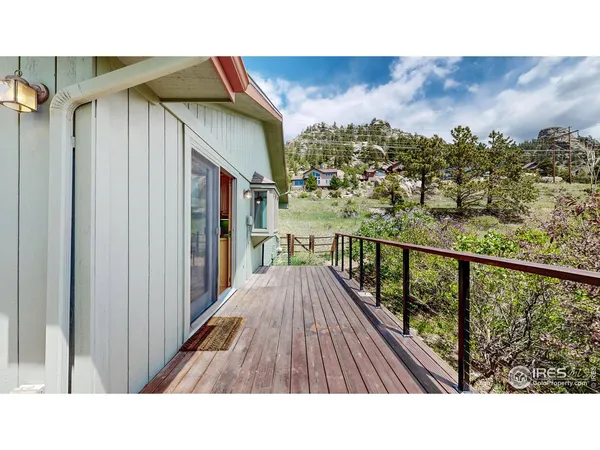 a balcony with wooden floor and city view