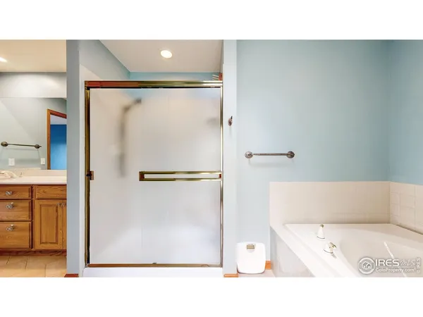 a bathroom with a tub and a shower