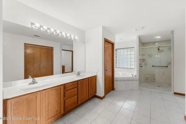 an aerial view of residential houses with outdoor space and swimming pool