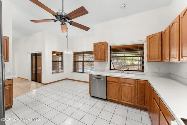 an empty room with fan and windows