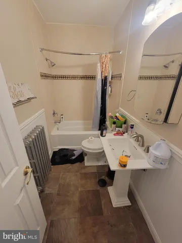a bathroom with a tub sink and a mirror