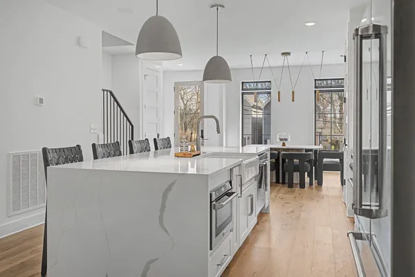 a kitchen with stainless steel appliances a sink stove and cabinets