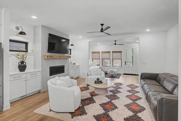 a living room with furniture fireplace and flat screen tv