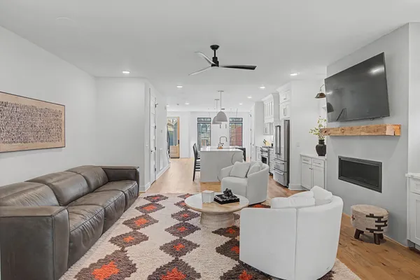 a living room with furniture a flat screen tv and a fireplace