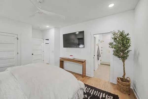 a bedroom with a bed and a flat screen tv