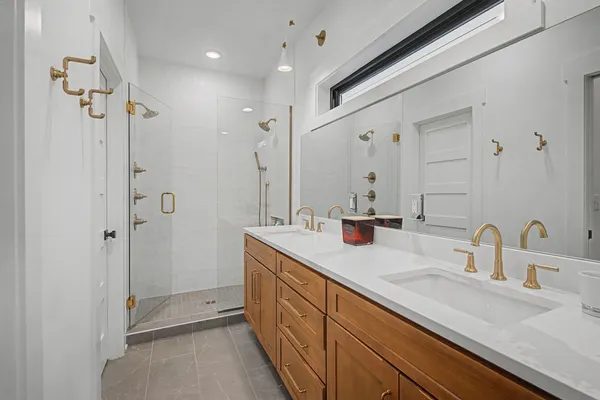 a bathroom with double sink and a mirror