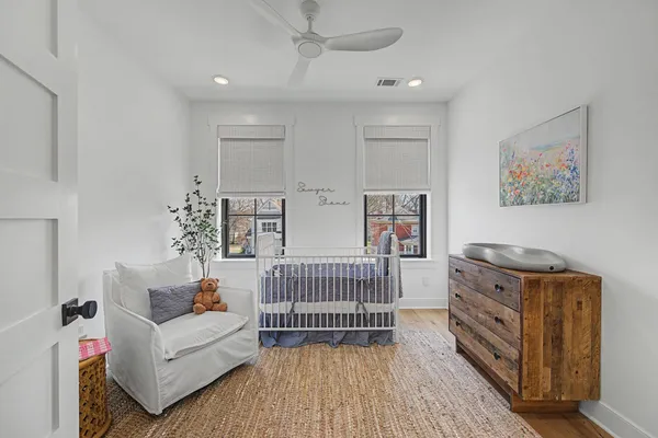 a bedroom with furniture and wooden floor