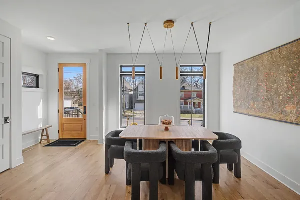 a view of a dining room with furniture and wooden floor