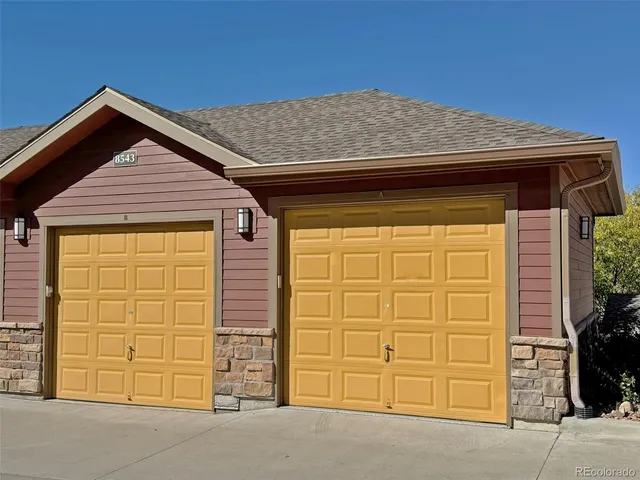 a view of a pathway of a house with a wooden fence