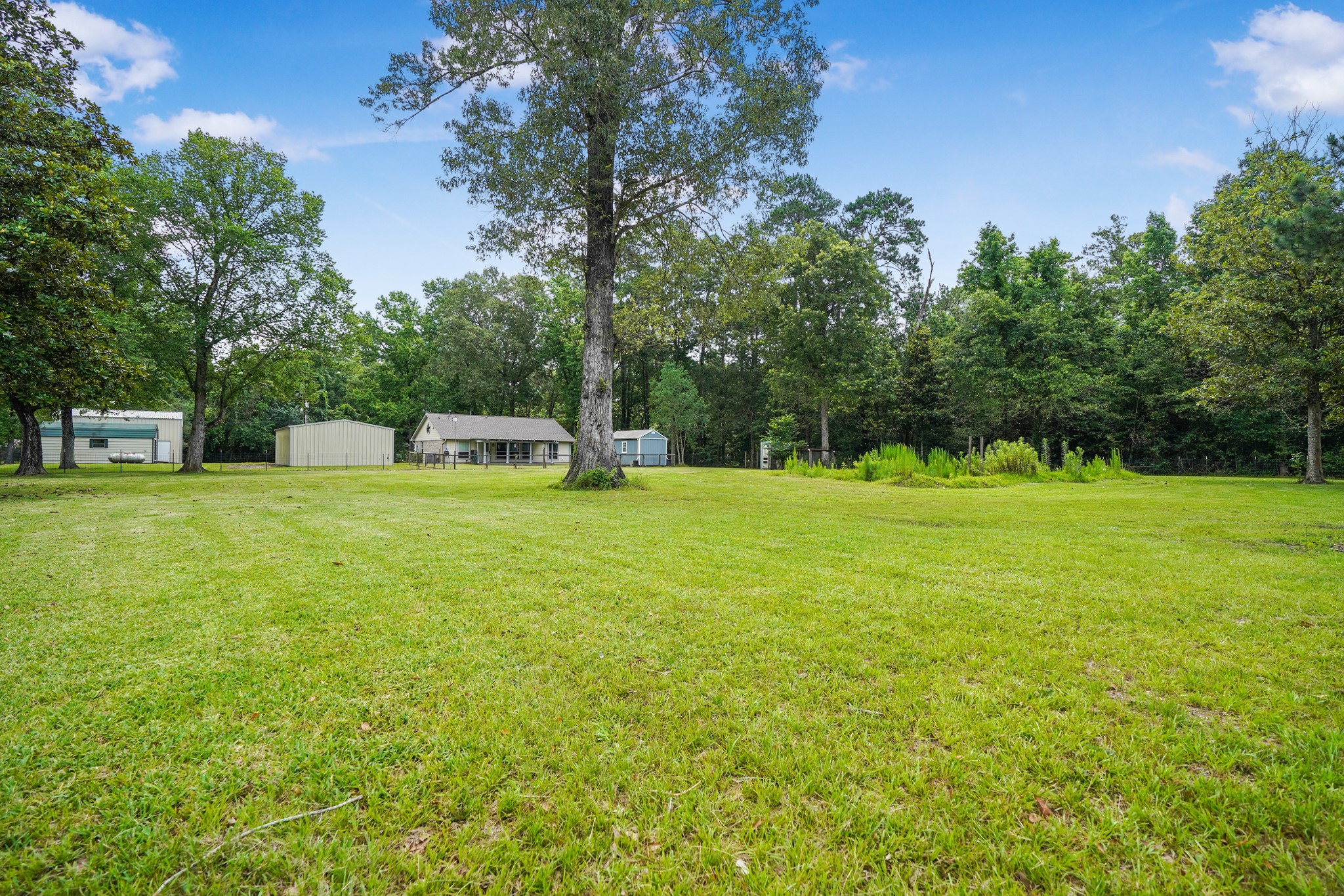 1003 Cherry Creek Road Dayton, TX 77535 - Photo 6 of 45 This view is from the back of the 2 acres looking to the back of the home.