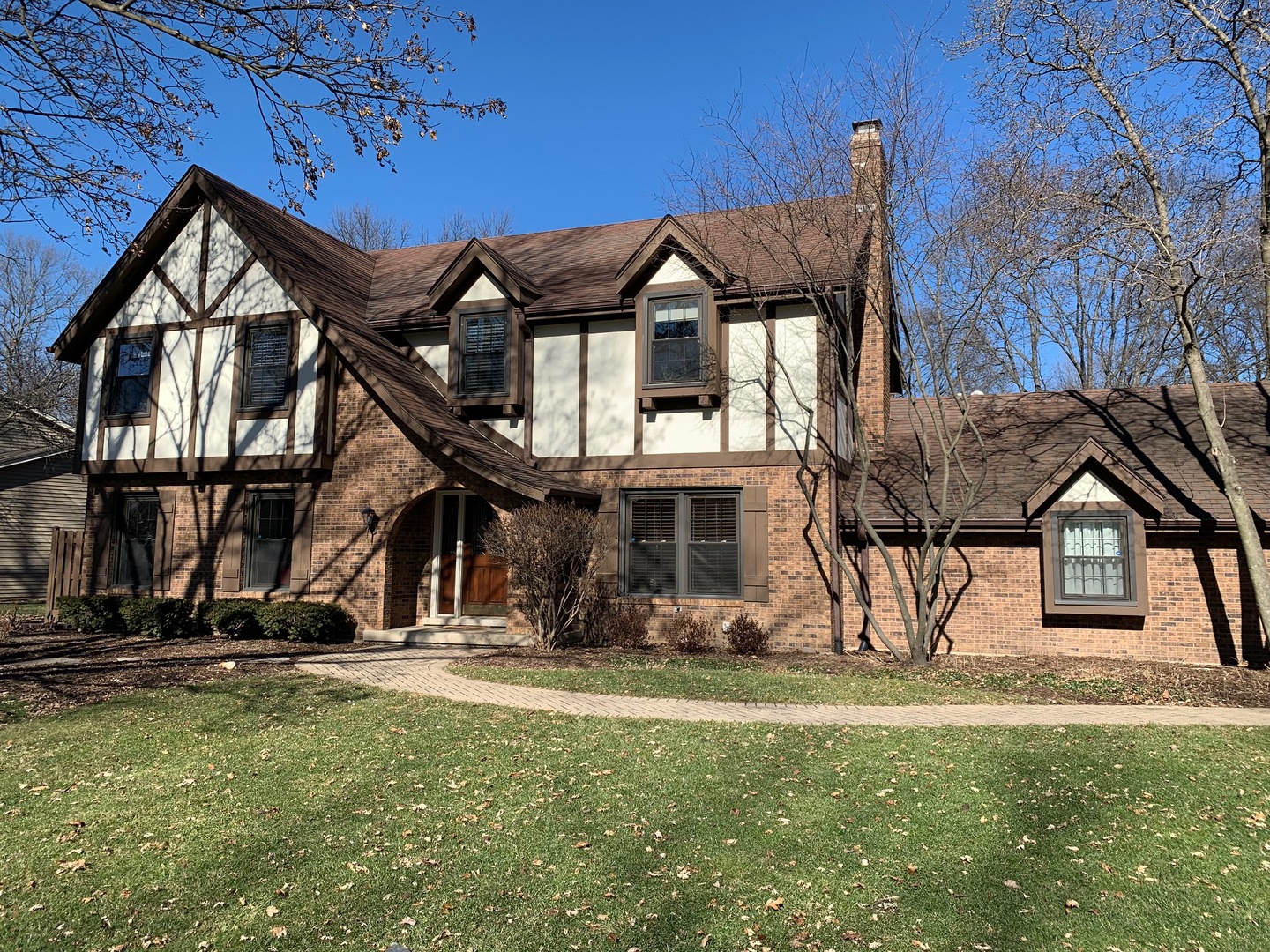 a view of a brick house with large windows
