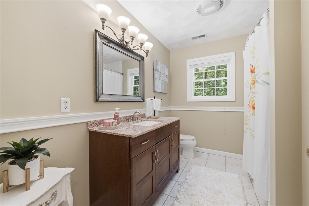 25 Haymeadow Road Boxford, MA 01921 - Photo 26 of 42 a bathroom with a toilet sink and mirror