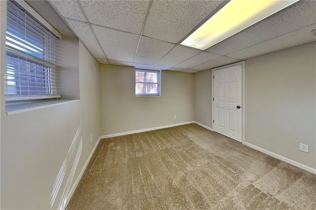 a view of an empty room with a kitchen