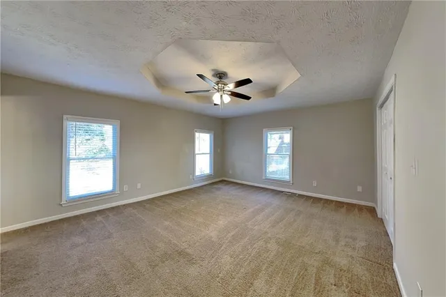 a view of an empty room with a ceiling fan