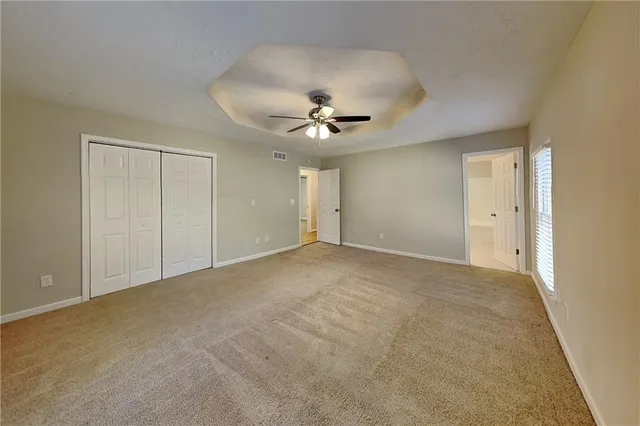 a spacious bathroom with a granite countertop sink and a mirror