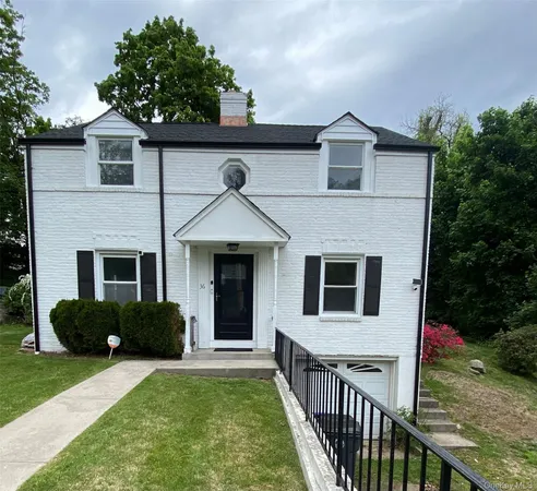 a front view of house with yard and green space