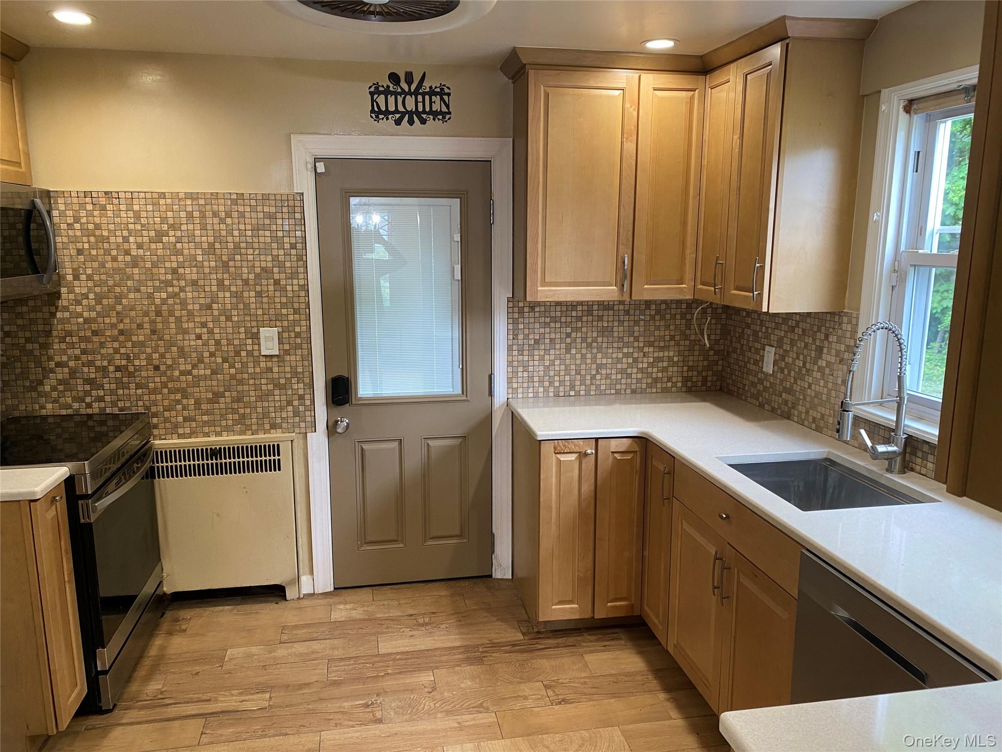 36 Maryton Road White Plains, NY 10603 - Photo 2 of 5 a kitchen with a refrigerator sink and cabinets
