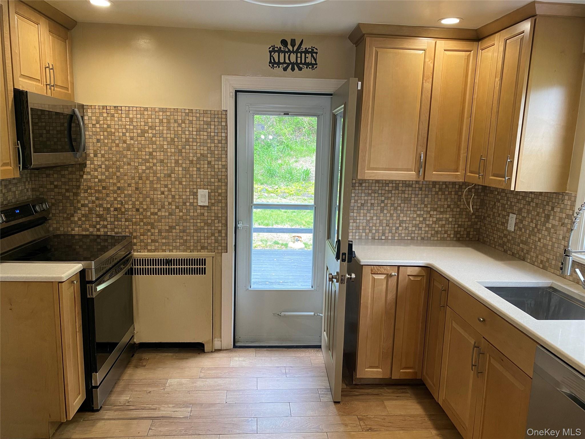 36 Maryton Road White Plains, NY 10603 - Photo 3 of 5 a kitchen with a refrigerator sink and microwave