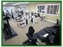a room with lots of chairs and mirrors