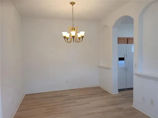 a view of a chandelier in a room with wooden floor