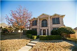 8208 Rincon Street Frisco, TX 75035 - Photo 1 of 1 Stone facade with arched and bay windows, featuring a prominent front entrance and a tiered walkway